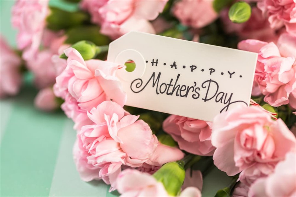 A bunch of flowers with a Happy Mother's Day gift tag